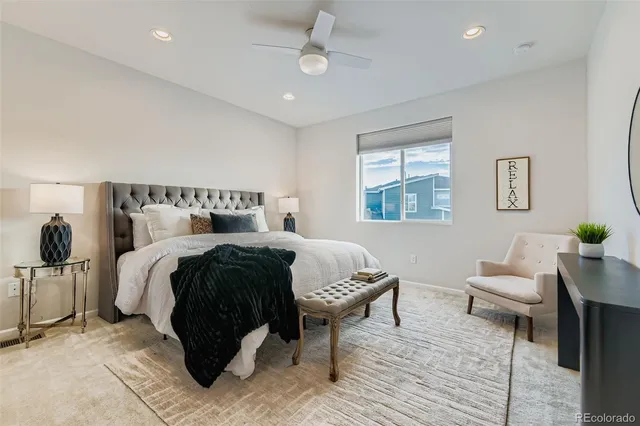 a bed room with a bed and a chair