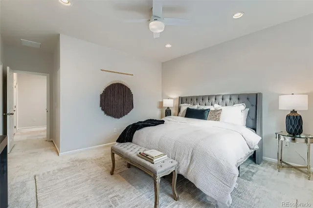 a bedroom with a bed a mirror and lamp