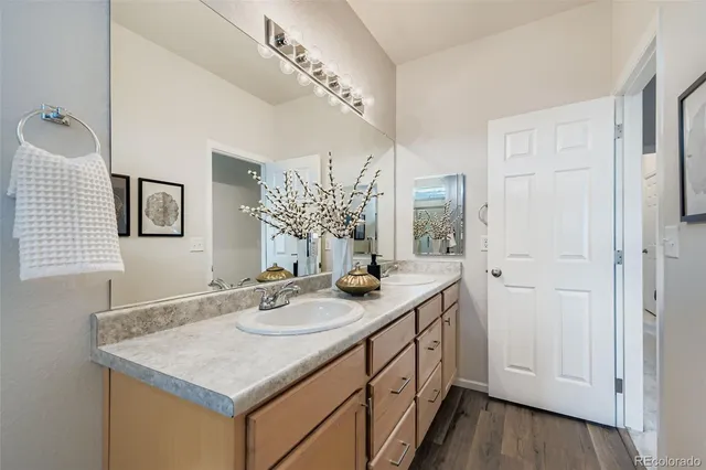 a bathroom with a granite countertop sink a large mirror and a window