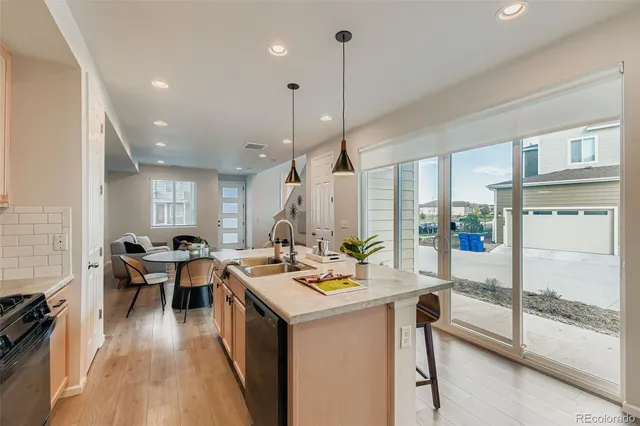 a open kitchen with stainless steel appliances granite countertop a sink stove and wooden floor