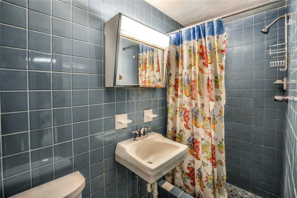 1289 Low Grade Road Harwick, PA 15049 - Photo 16 of 19 This full ceramic LL bath adjacent to the game room comes complete with a large shower and new comfort level Kohler toilet.
