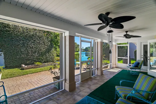 a view of a porch with furniture and a yard