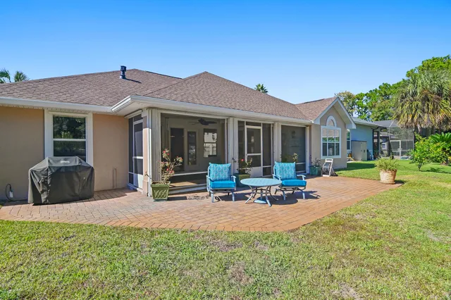 a view of a house with backyard porch and sitting area