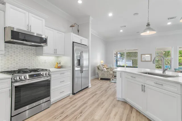 a kitchen with a stove a sink and a refrigerator