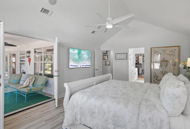 a spacious bedroom with a bed and a table in it