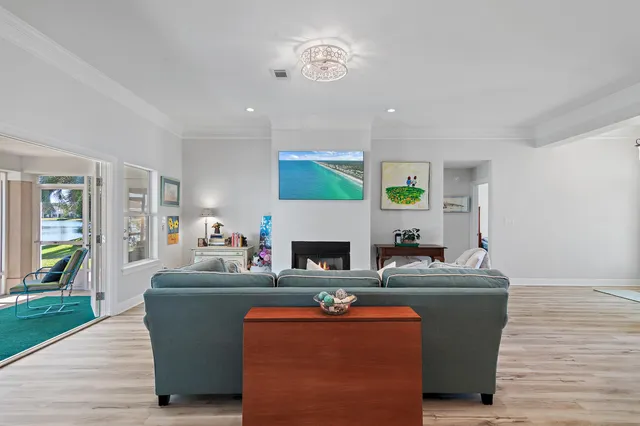 a living room with fireplace furniture and a wooden floor