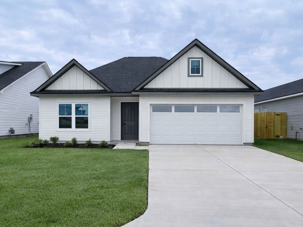 25696 John Wayne Drive Splendora, TX 77372 - Photo 1 of 6 a front view of house with yard and green space