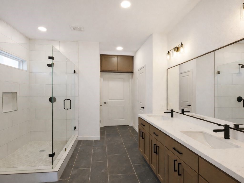 25696 John Wayne Drive Splendora, TX 77372 - Photo 5 of 6 a spacious bathroom with a double vanity sink a large mirror and shower