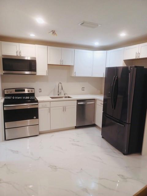 Kendall Green Pompano Beach, FL 33060 - Photo 2 of 8 a kitchen with stainless steel appliances granite countertop a refrigerator stove a sink and dishwasher