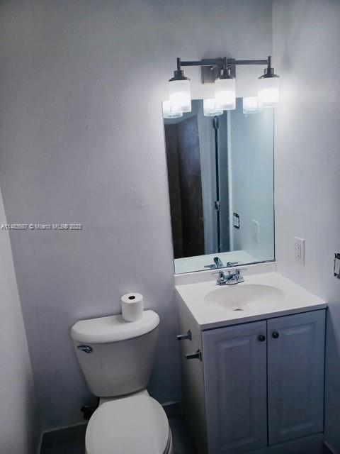 Kendall Green Pompano Beach, FL 33060 - Photo 5 of 8 a bathroom with a toilet sink and mirror