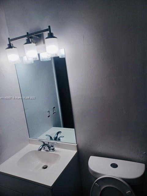 Kendall Green Pompano Beach, FL 33060 - Photo 7 of 8 a bathroom with a sink toilet and mirror