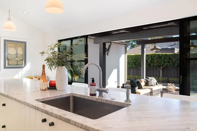 a kitchen with a sink and large window
