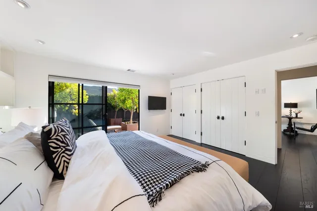 a bedroom with a large bed and a large window