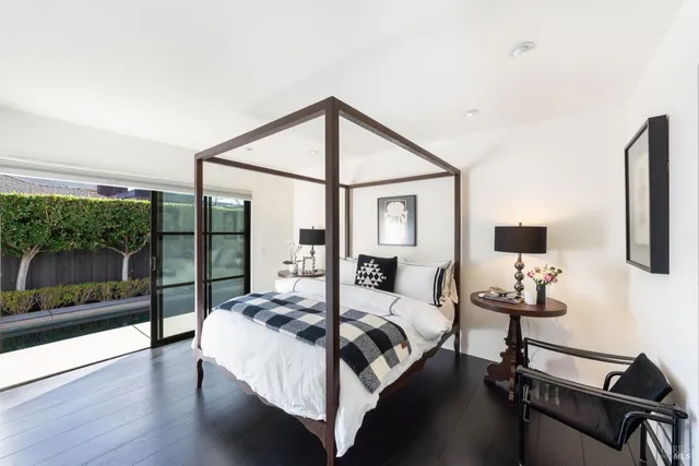 a bedroom with a bed and a flat tv screen on the dresser
