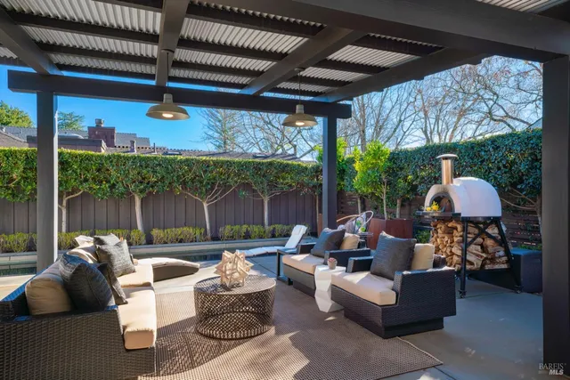 a outdoor living space with furniture potted plant and a large window