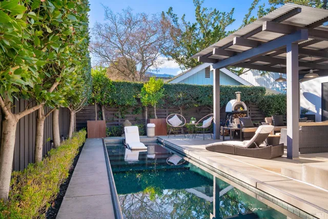 a view of a patio with a table chairs and a backyard
