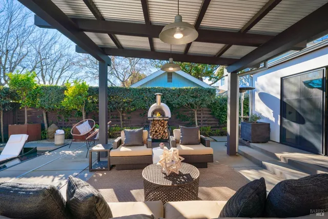 a living room with patio furniture and a fireplace