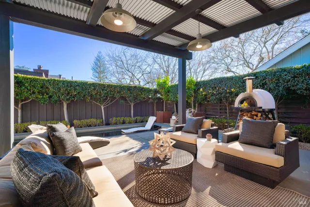 a outdoor space with patio couch and a fireplace