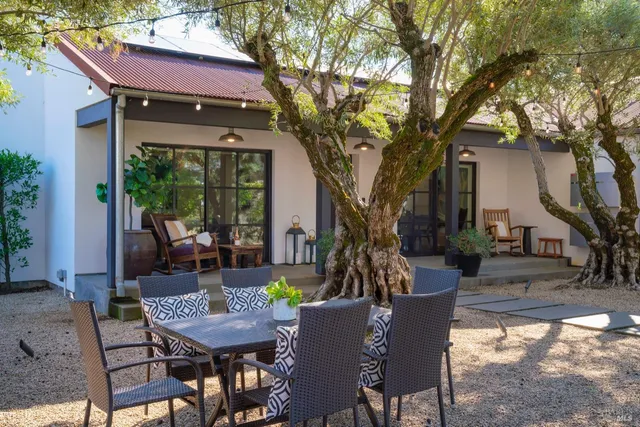 a view of a house with backyard and sitting area