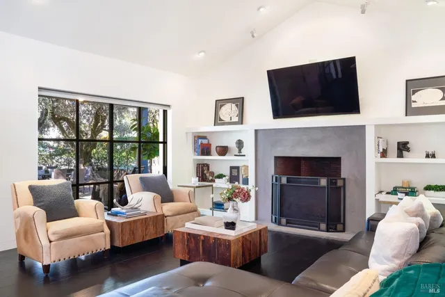 a living room with furniture fireplace and a flat screen tv