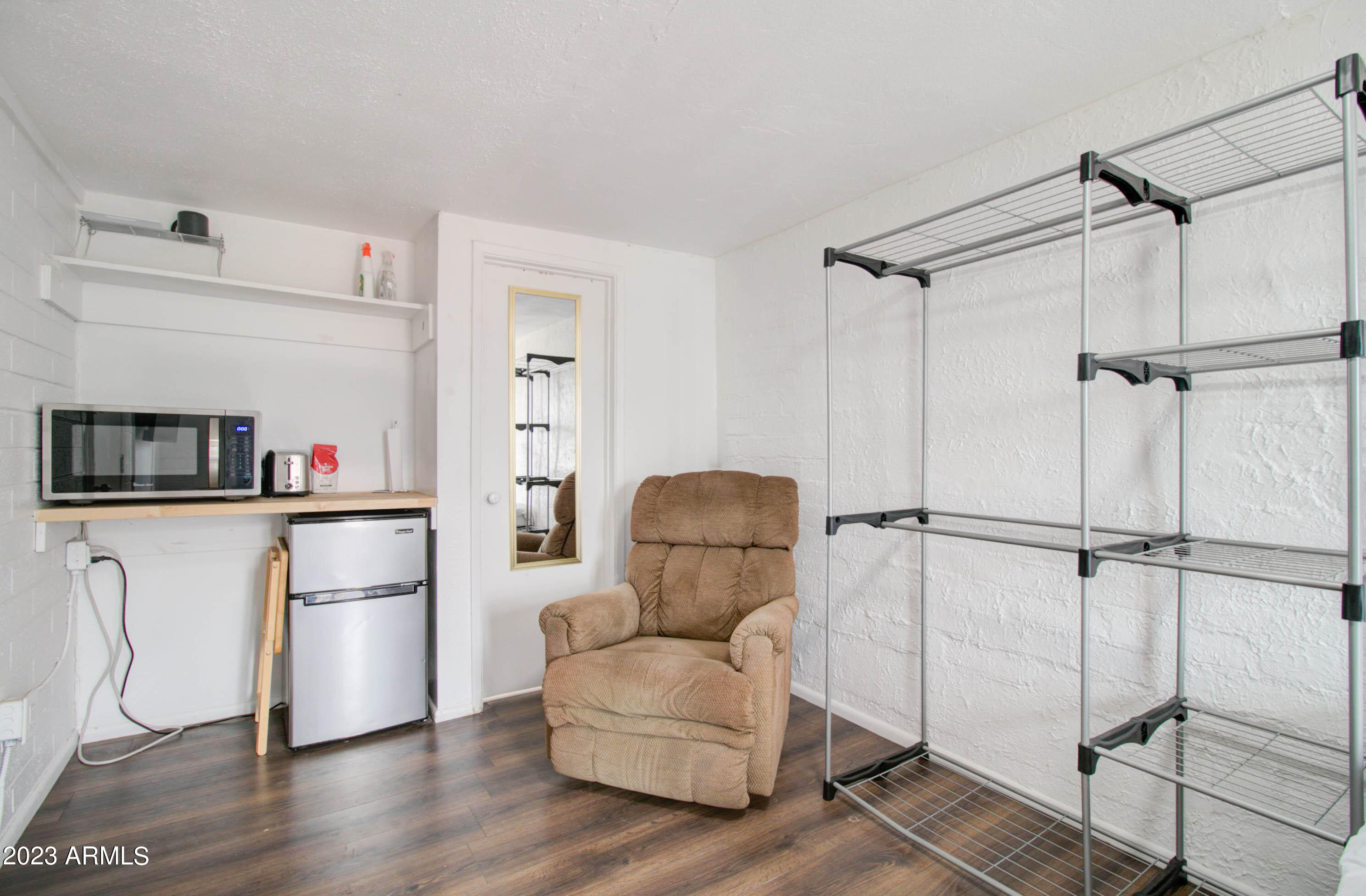 877 East Sycamore Street, Unit D Globe, AZ 85501 - Photo 1 of 4 a living room with furniture and a refrigerator