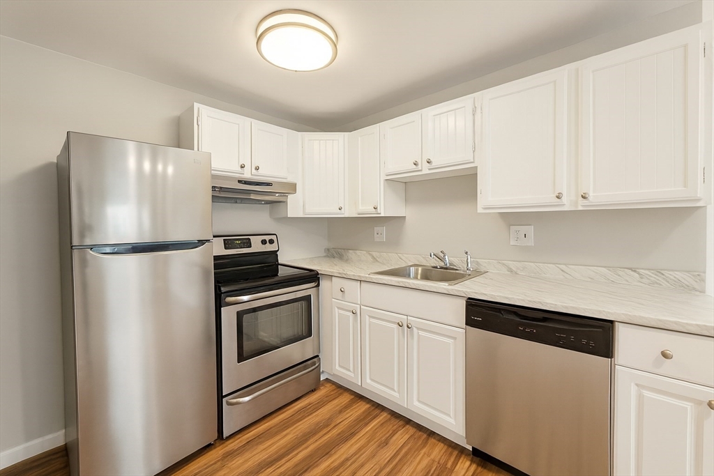 38 Carey Avenue, Unit 3 Watertown, MA 02472 - Photo 2 of 11 a kitchen with cabinets stainless steel appliances and a counter space