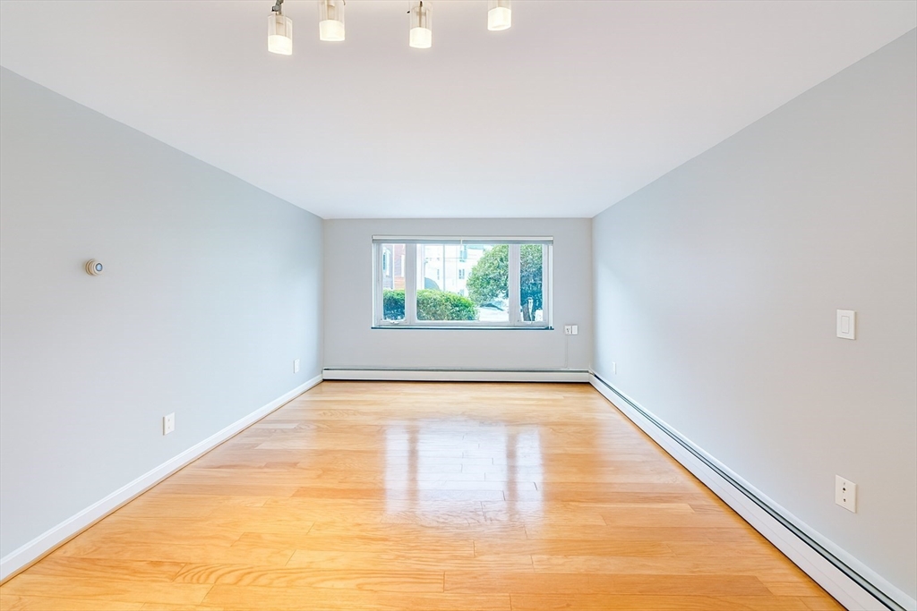 38 Carey Avenue, Unit 3 Watertown, MA 02472 - Photo 4 of 11 a view of an empty room with windows