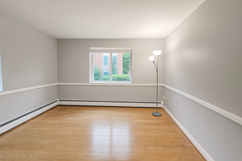38 Carey Avenue, Unit 3 Watertown, MA 02472 - Photo 5 of 11 a view of a room with wooden floor and a window