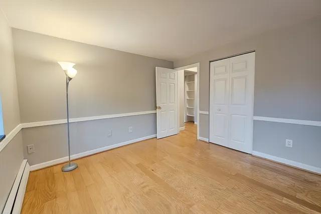 a view of an empty room with closet area