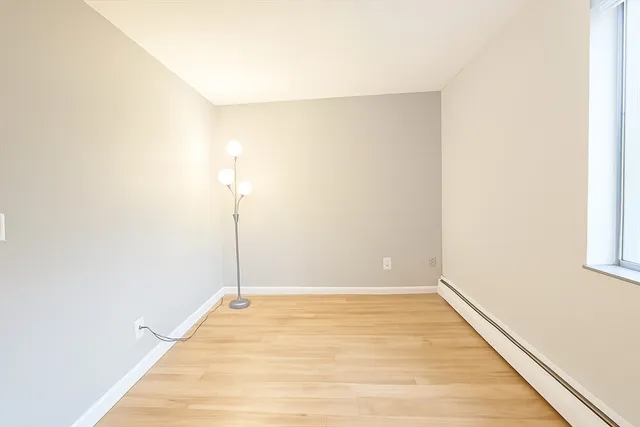 a view of a room with wooden floor
