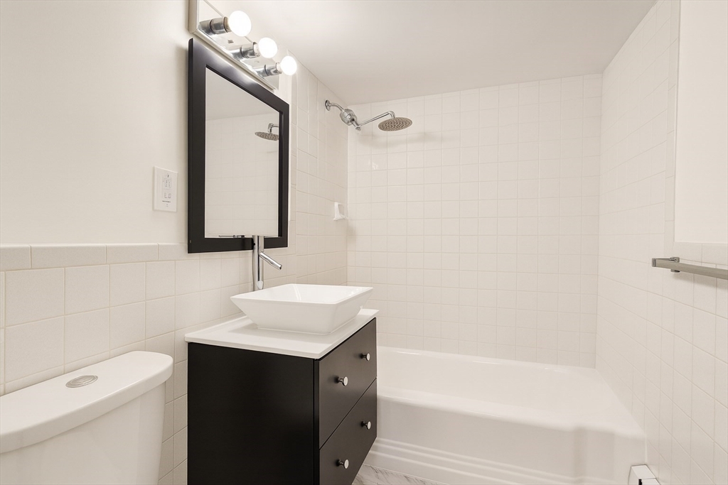 38 Carey Avenue, Unit 3 Watertown, MA 02472 - Photo 10 of 11 a bathroom with a sink a toilet and shower