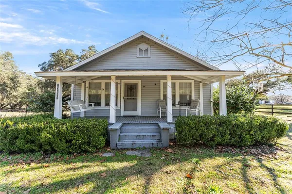 a living room with furniture a rug and a window