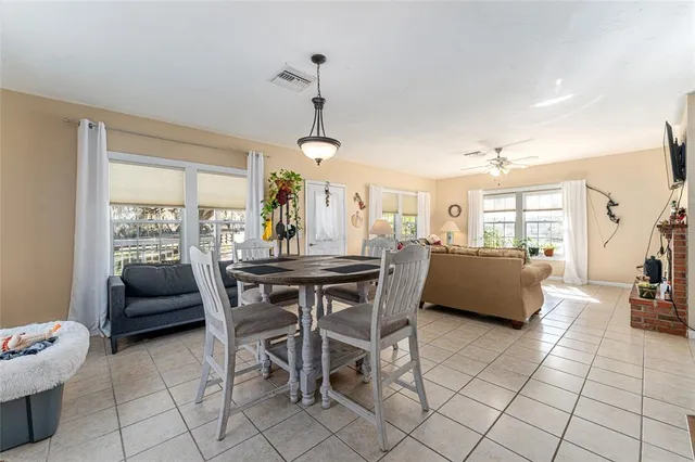 a bedroom with a bed and large windows