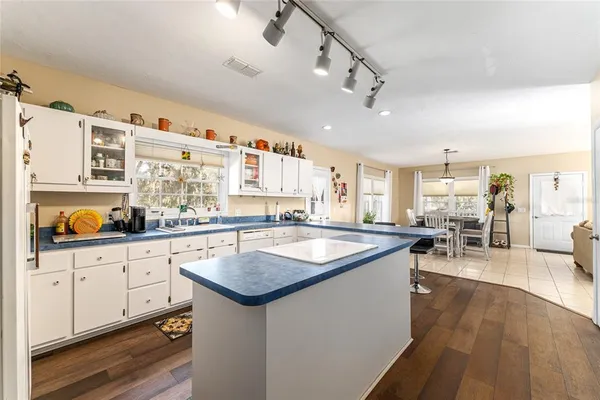 a bedroom with a bed and large windows