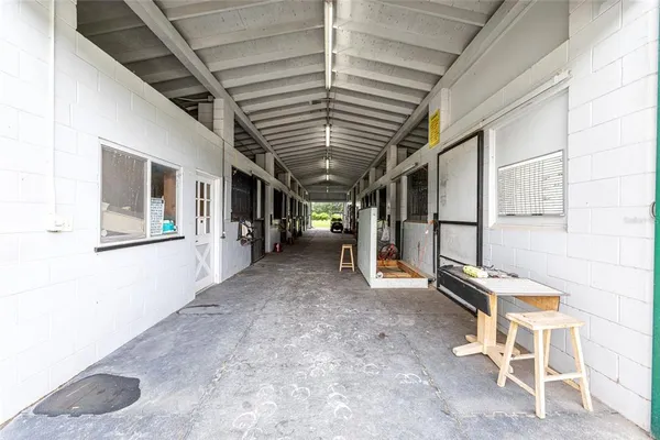 a view of a patio with a table and chairs under an umbrella