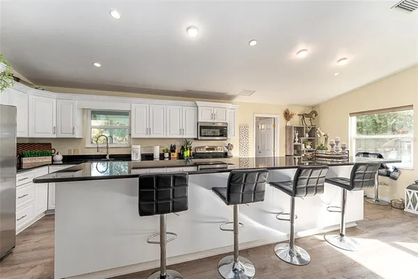 a bathroom with a double vanity sink mirror and shower