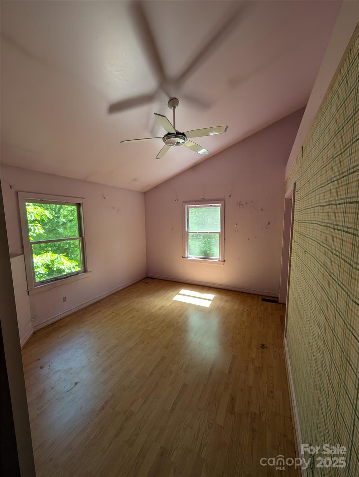 720 New Market Road Tryon, NC 28782 - Photo 12 of 15 an empty room with windows and fan