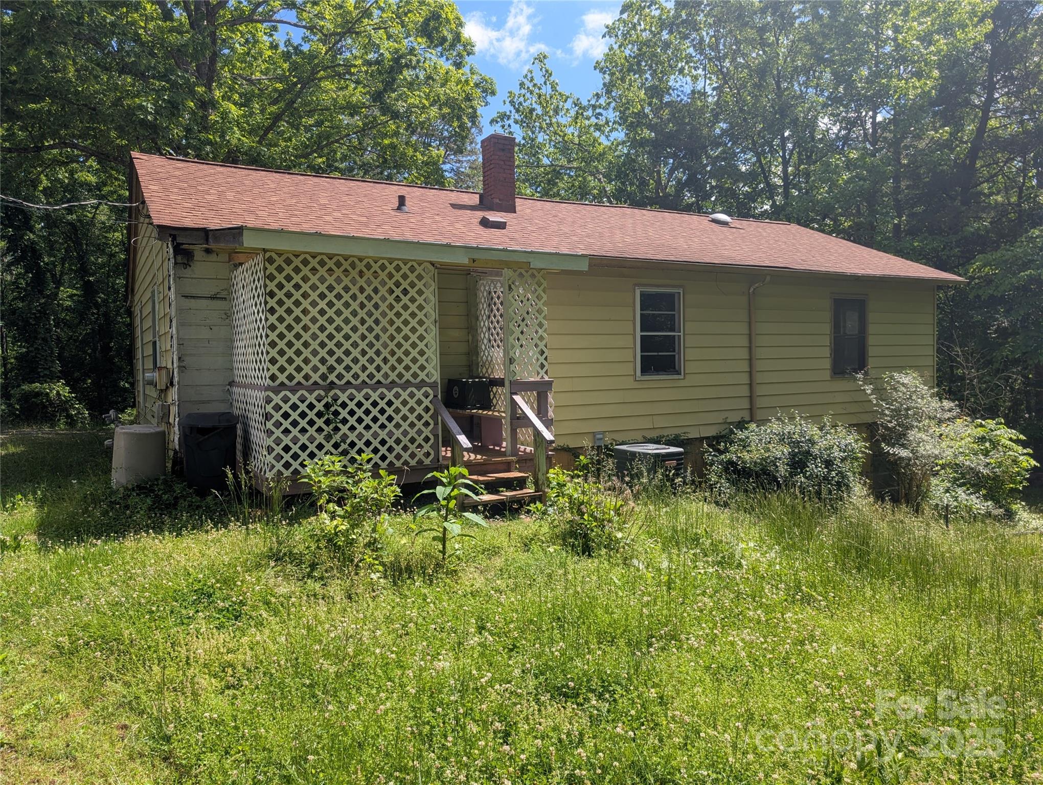 720 New Market Road Tryon, NC 28782 - Photo 2 of 15 a front view of a house with garden