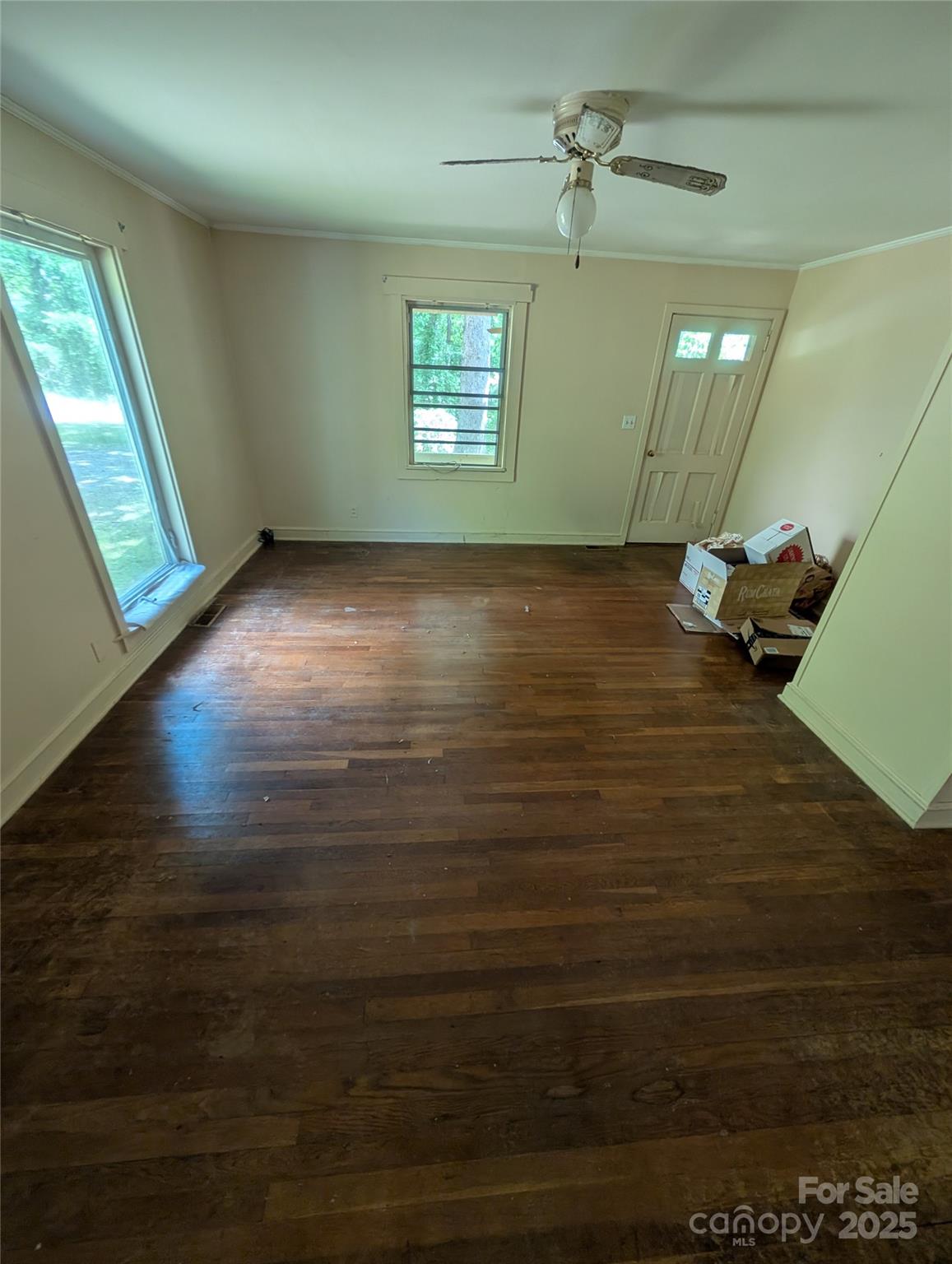 720 New Market Road Tryon, NC 28782 - Photo 9 of 15 an empty room with wooden floor and windows