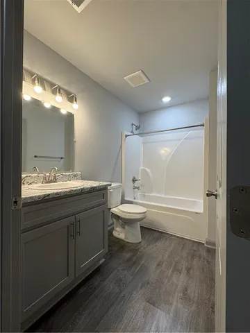 a bathroom with a double vanity sink toilet and shower