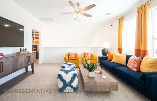 a living room with furniture and a flat screen tv