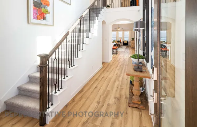 a view of entryway and hall with wooden floor