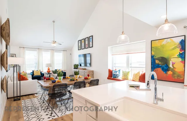 a living room with furniture a rug and a flat screen tv
