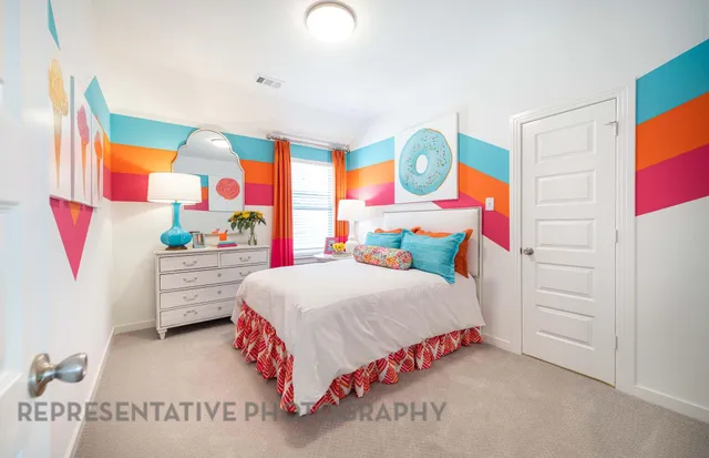 a bedroom with a bed and a dresser