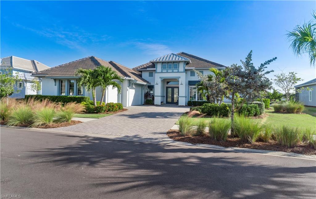 6254 Lightbourn Way Naples, FL 34113 - Photo 1 of 34 a front view of a house with a yard