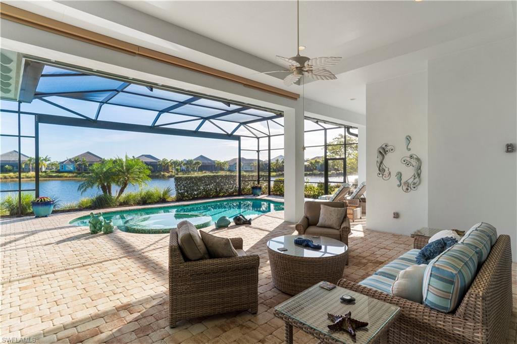 6254 Lightbourn Way Naples, FL 34113 - Photo 11 of 34 a living room with furniture and a floor to ceiling window