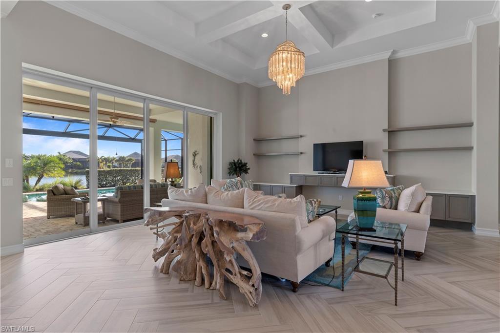 6254 Lightbourn Way Naples, FL 34113 - Photo 13 of 34 a living room with furniture chandelier and a large window