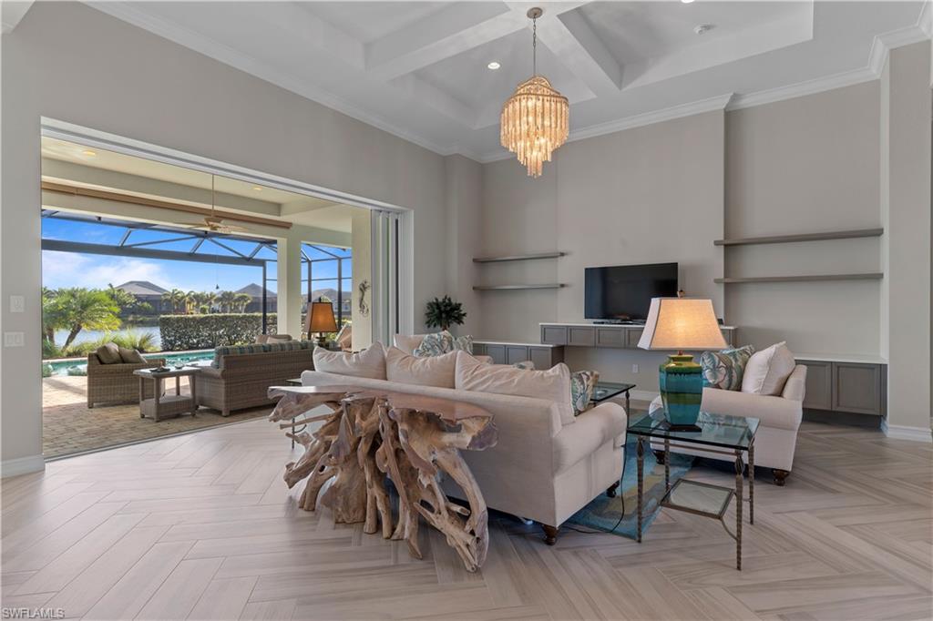 6254 Lightbourn Way Naples, FL 34113 - Photo 14 of 34 a living room with furniture chandelier and a large window