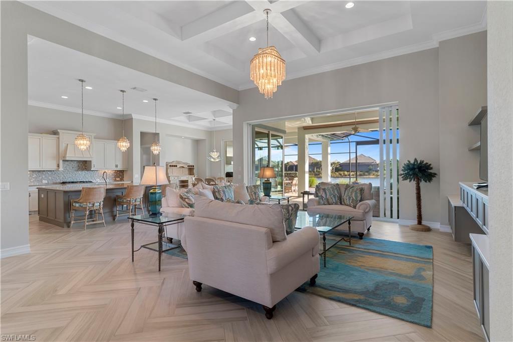 6254 Lightbourn Way Naples, FL 34113 - Photo 15 of 34 a living room with fireplace furniture and a chandelier