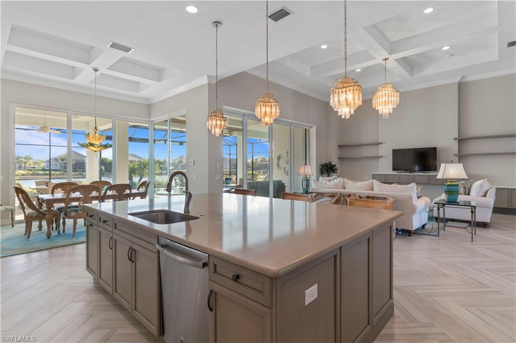6254 Lightbourn Way Naples, FL 34113 - Photo 17 of 34 a large kitchen with lots of counter space and living room